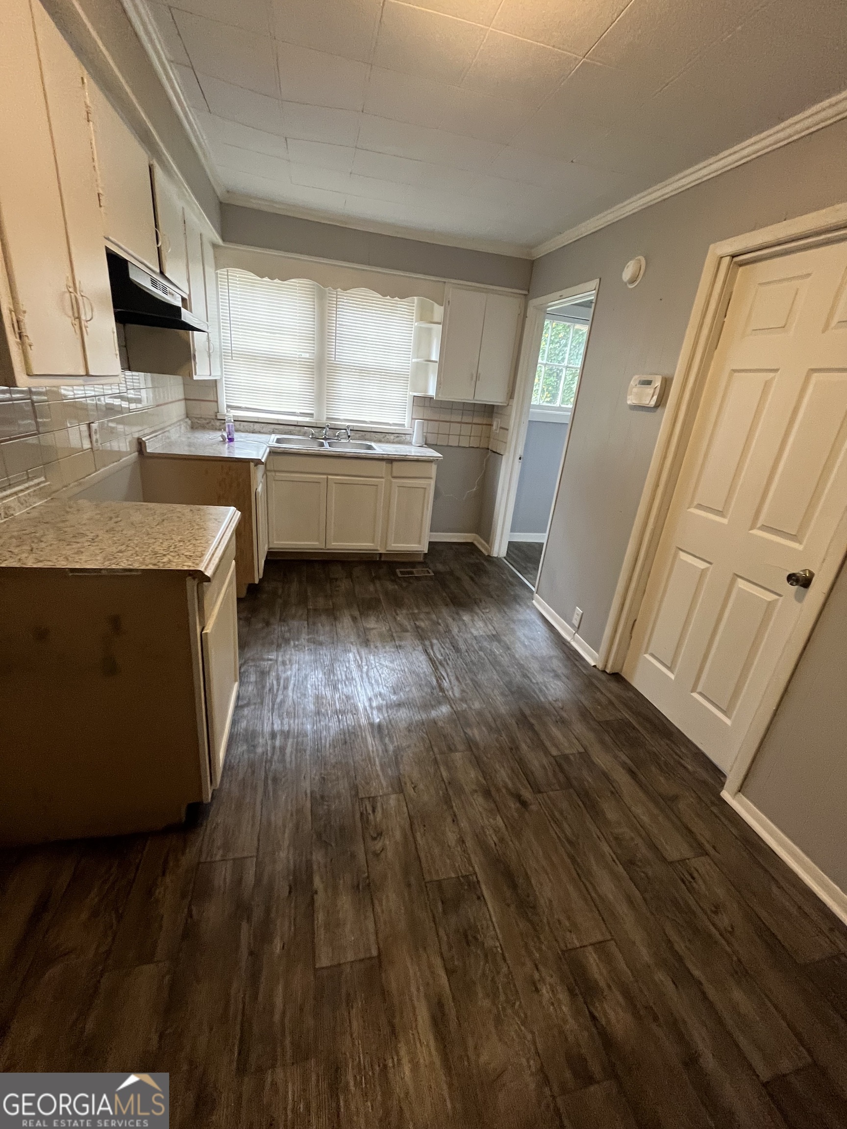 3423 Flamingo Drive Macon, GA 31206 - Photo 2 of 6 a kitchen with wooden floors and white appliances