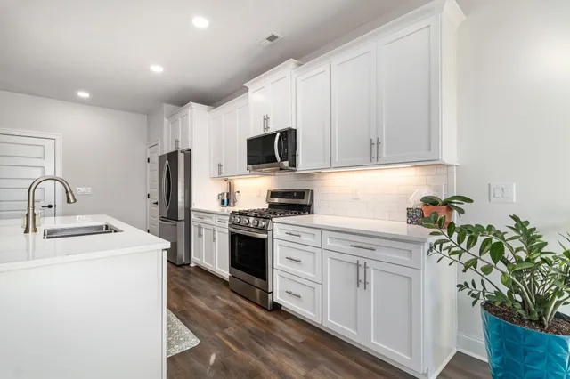 a kitchen with appliances a sink and a counter top space