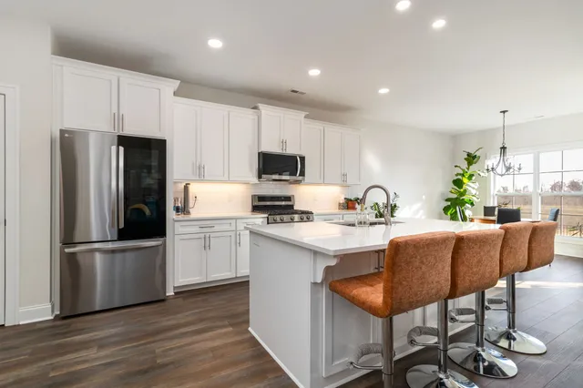 a kitchen with refrigerator and microwave