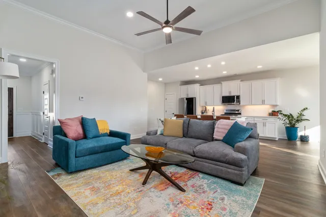 a living room with furniture and kitchen view