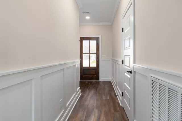 a view of hallway with wooden floor