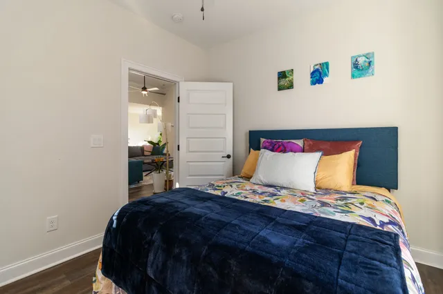 a bedroom with bed and wooden floor