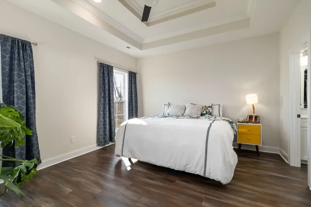 a bedroom with a bed and a dresser in it