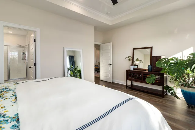 a spacious bathroom with a double vanity sink a mirror and a shower
