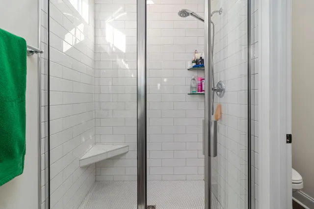 a view of walk in closet with clothes