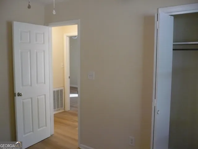 a view of a hallway with wooden floor