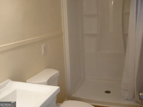 a bathroom with a shower and toilet