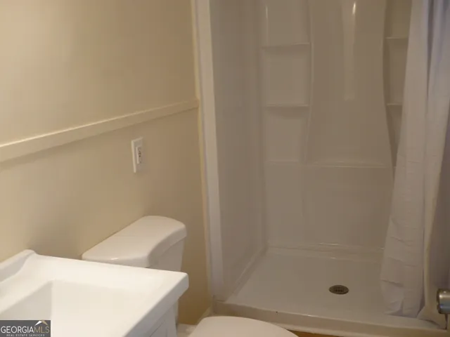 a bathroom with a shower and toilet