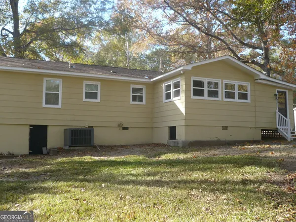 a house that has a tree in front of the house