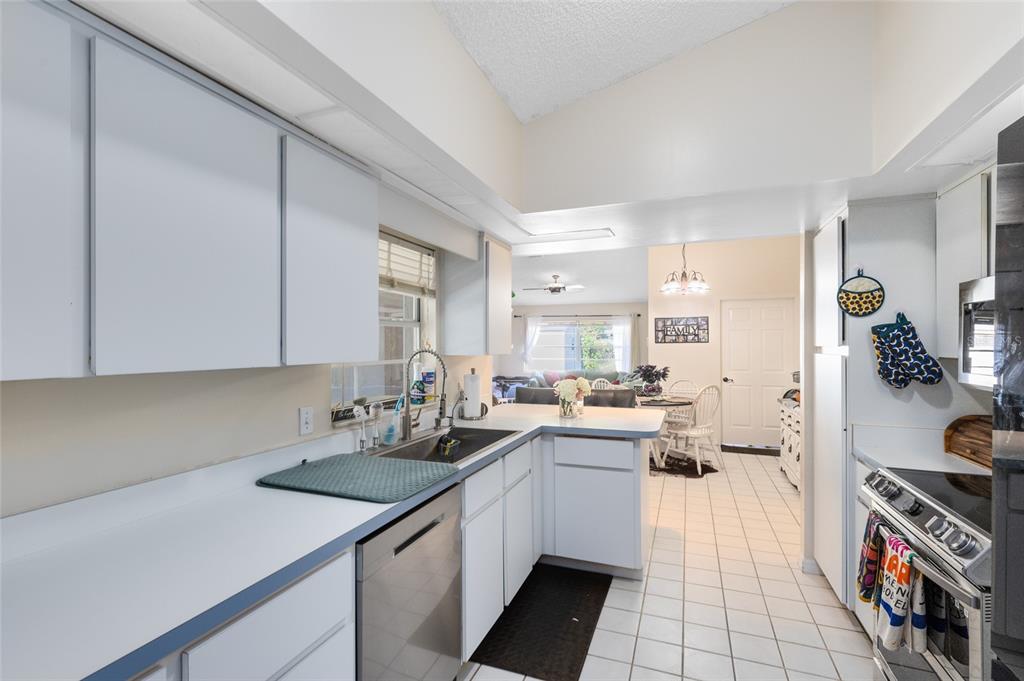130 Laurianne Road DeBary, FL 32713 - Photo 11 of 34 a kitchen with a sink a stove and cabinets