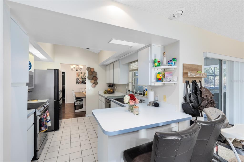 130 Laurianne Road DeBary, FL 32713 - Photo 12 of 34 a view of a dining room with furniture and a kitchen