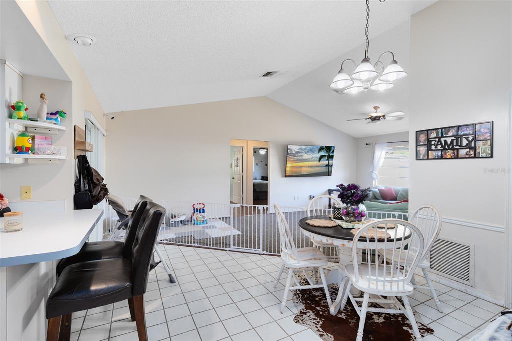 130 Laurianne Road DeBary, FL 32713 - Photo 13 of 34 a view of a dining room with furniture and chandelier