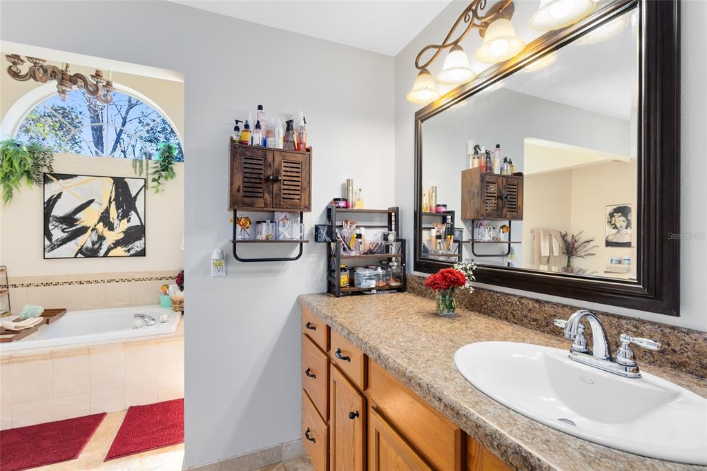 130 Laurianne Road DeBary, FL 32713 - Photo 18 of 34 a bathroom with a sink double vanity and a window