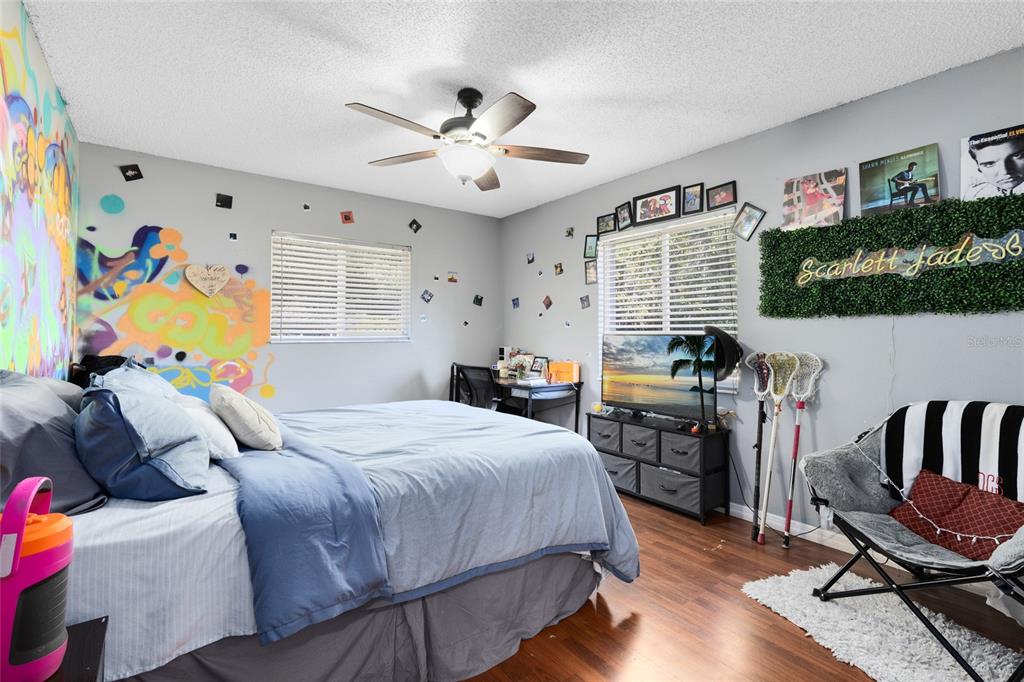 130 Laurianne Road DeBary, FL 32713 - Photo 20 of 34 a bedroom with a bed furniture and a flat screen tv