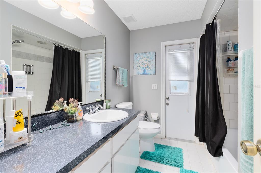 130 Laurianne Road DeBary, FL 32713 - Photo 21 of 34 a bathroom with a granite countertop sink and a mirror