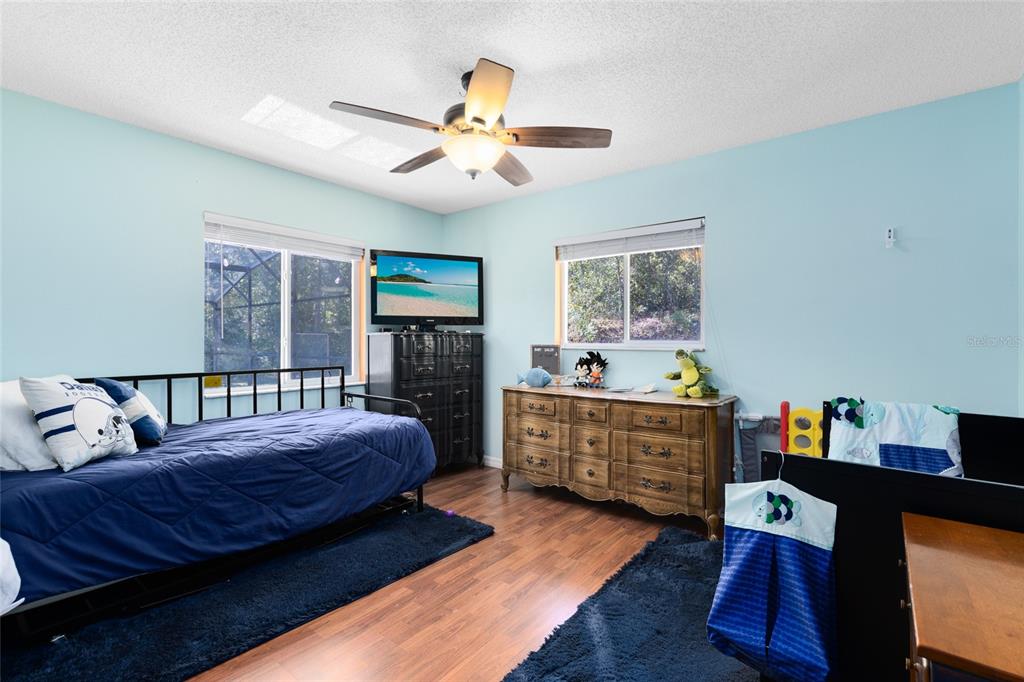 130 Laurianne Road DeBary, FL 32713 - Photo 22 of 34 a bedroom with a bed and a chandelier