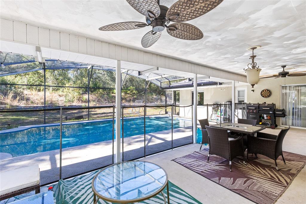 130 Laurianne Road DeBary, FL 32713 - Photo 23 of 34 a living room with furniture and a floor to ceiling window