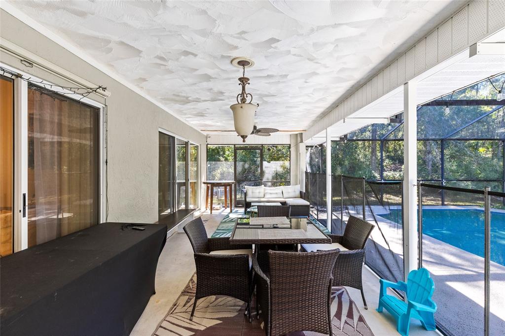 130 Laurianne Road DeBary, FL 32713 - Photo 24 of 34 a view of a dining room with furniture large windows and wooden floor
