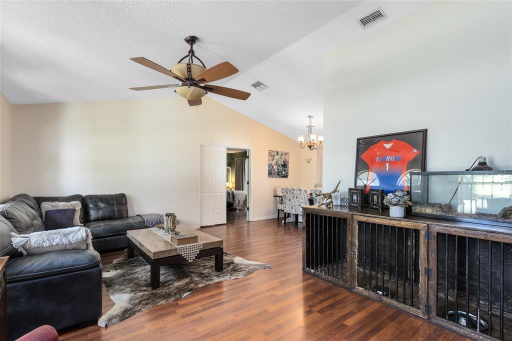 130 Laurianne Road DeBary, FL 32713 - Photo 8 of 34 a living room with furniture a rug and a chandelier