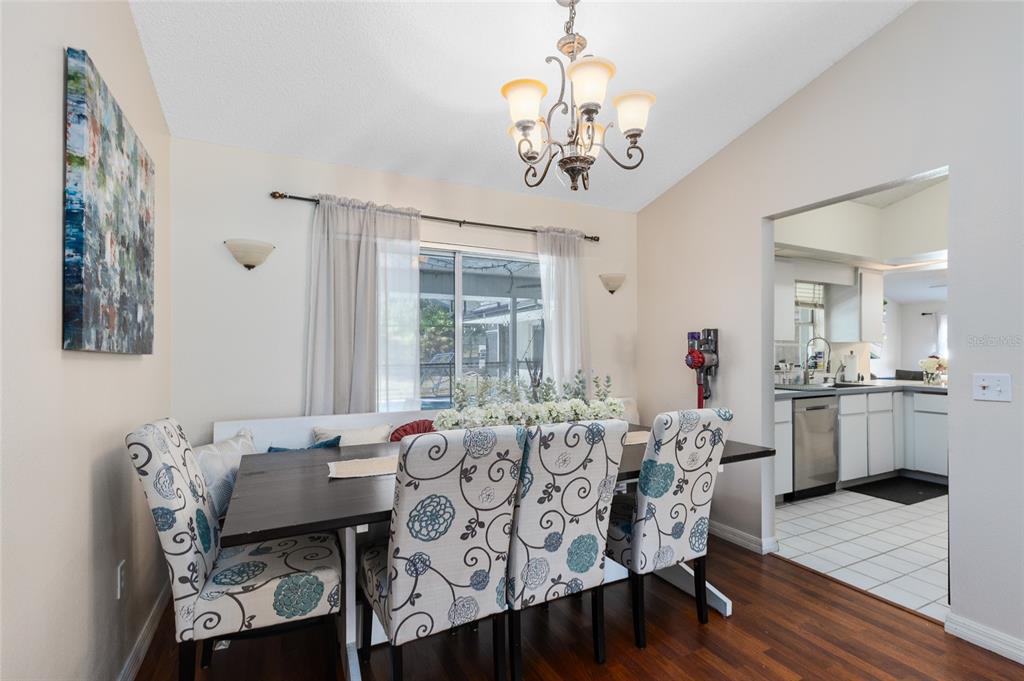 130 Laurianne Road DeBary, FL 32713 - Photo 9 of 34 a view of a dining room with furniture wooden floor and chandelier