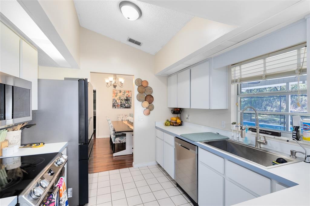 130 Laurianne Road DeBary, FL 32713 - Photo 10 of 34 a kitchen that has a lot of cabinets a sink and a stove in it