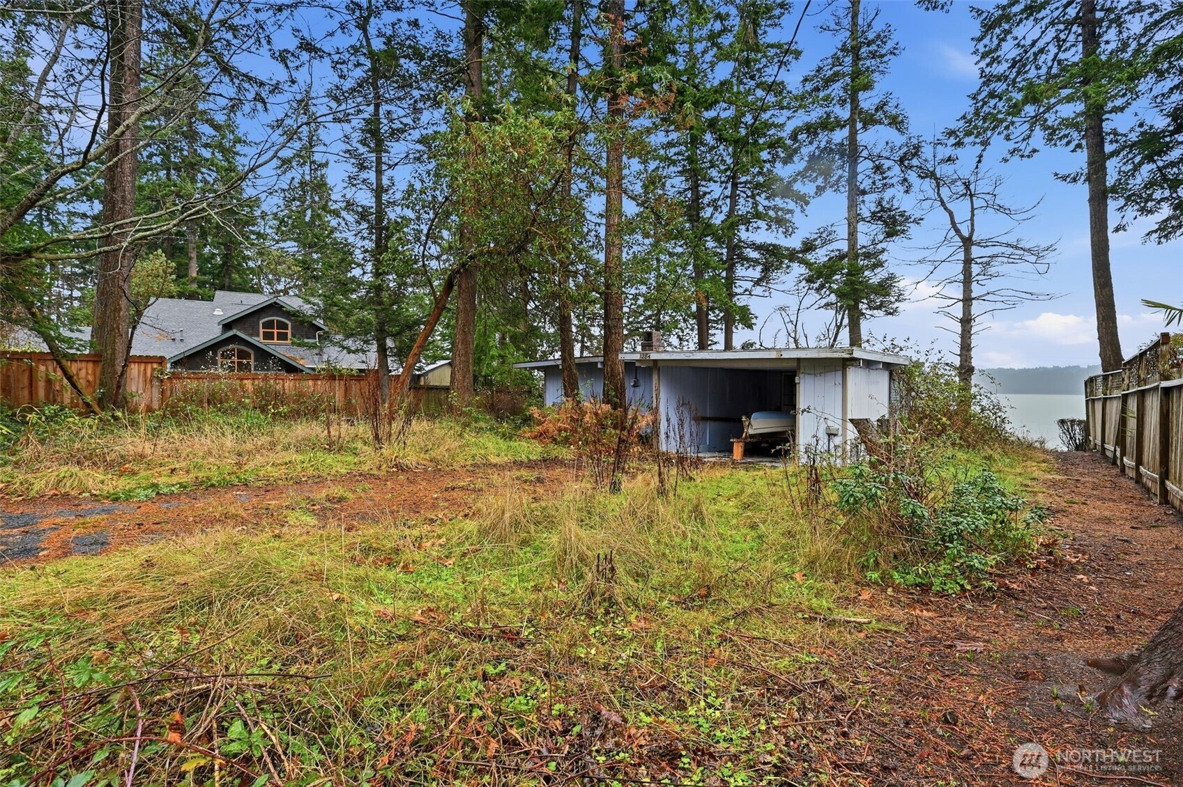 1284 Dines Point Road Greenbank, WA 98253 - Photo 2 of 23 a view of a yard with plants and a tree