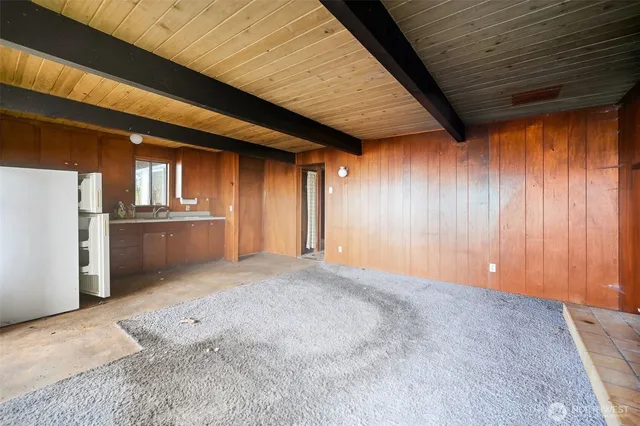 an empty room with closet and windows