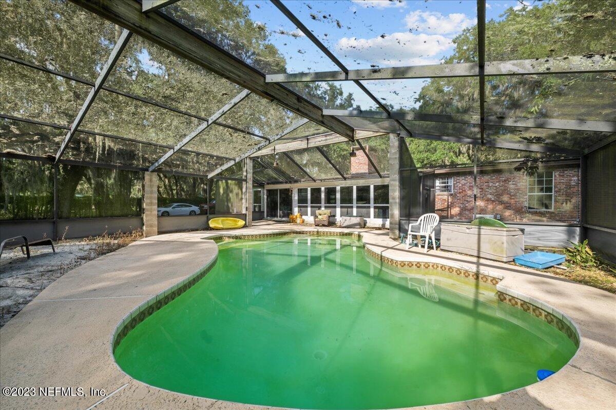 7145 Fitzpatrick Lane Jacksonville, FL 32226 - Photo 16 of 42 a view of a swimming pool with a patio