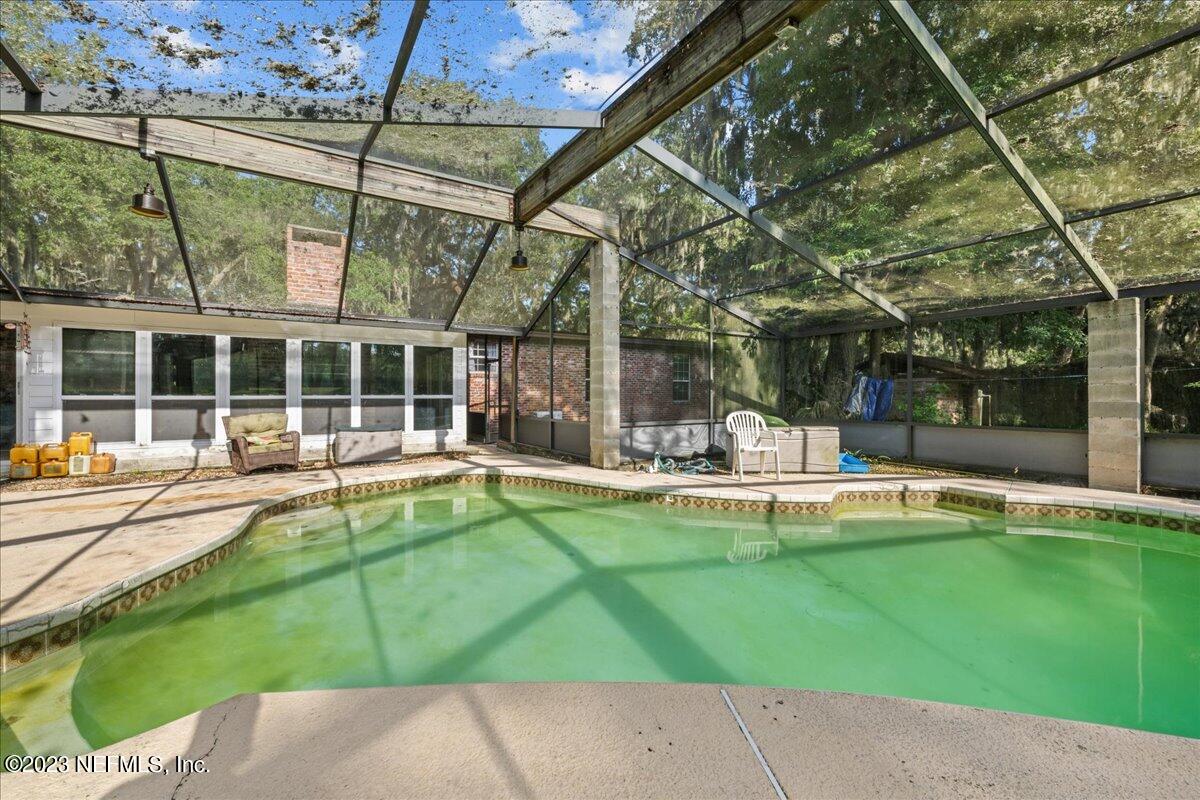 7145 Fitzpatrick Lane Jacksonville, FL 32226 - Photo 17 of 42 a view of a swimming pool with a patio