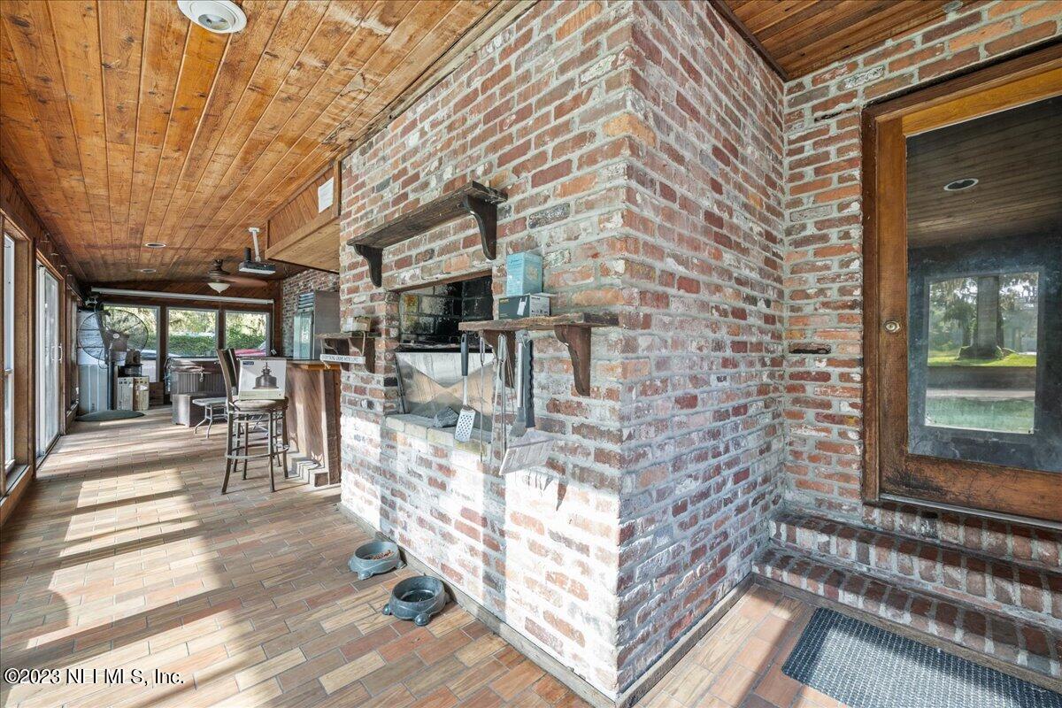 7145 Fitzpatrick Lane Jacksonville, FL 32226 - Photo 19 of 42 a view of a patio with table and chairs and potted plants