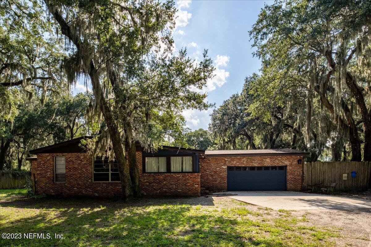 7145 Fitzpatrick Lane Jacksonville, FL 32226 - Photo 2 of 42 a view of house with yard and garage
