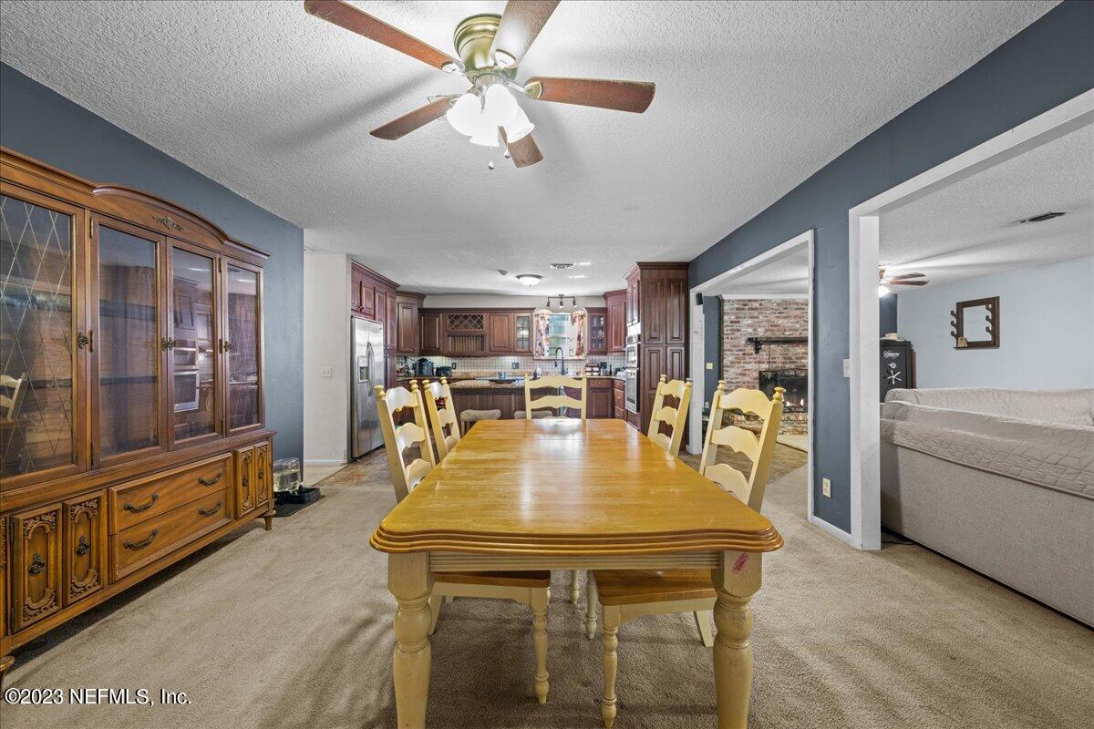 7145 Fitzpatrick Lane Jacksonville, FL 32226 - Photo 26 of 42 a view of a dining room with furniture window and wooden floor