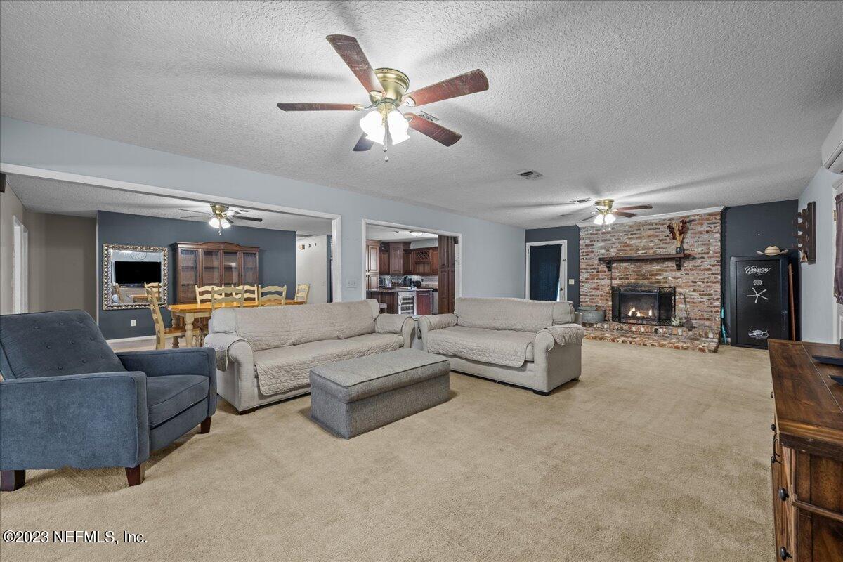 7145 Fitzpatrick Lane Jacksonville, FL 32226 - Photo 27 of 42 a living room with furniture and a chandelier