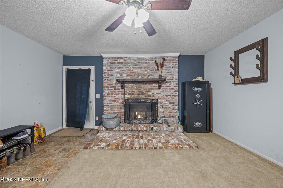 7145 Fitzpatrick Lane Jacksonville, FL 32226 - Photo 28 of 42 a living room with a fireplace