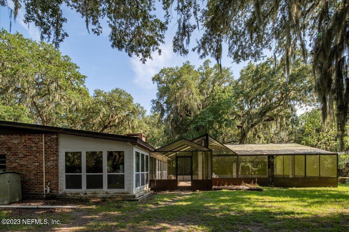 7145 Fitzpatrick Lane Jacksonville, FL 32226 - Photo 3 of 42 a front view of a house with a garden