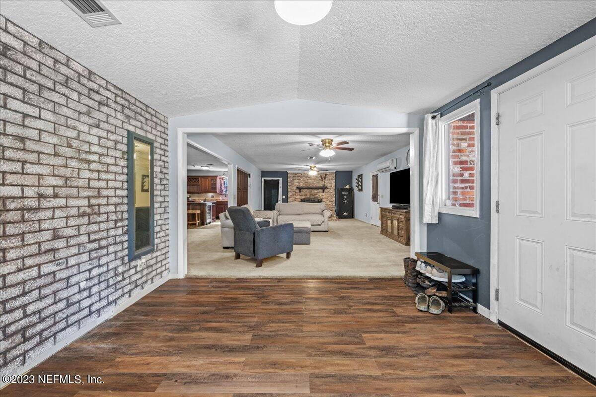 7145 Fitzpatrick Lane Jacksonville, FL 32226 - Photo 31 of 42 a living room with furniture and a flat screen tv