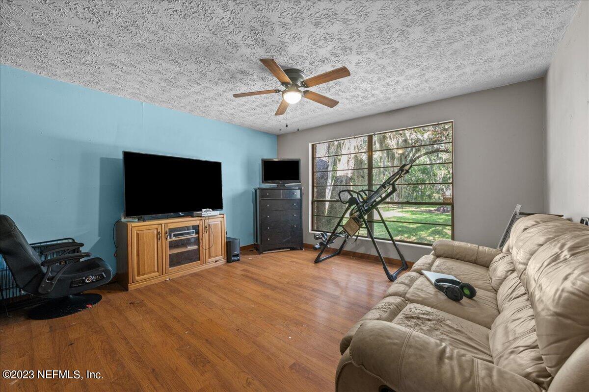 7145 Fitzpatrick Lane Jacksonville, FL 32226 - Photo 33 of 42 a living room with furniture and a flat screen tv