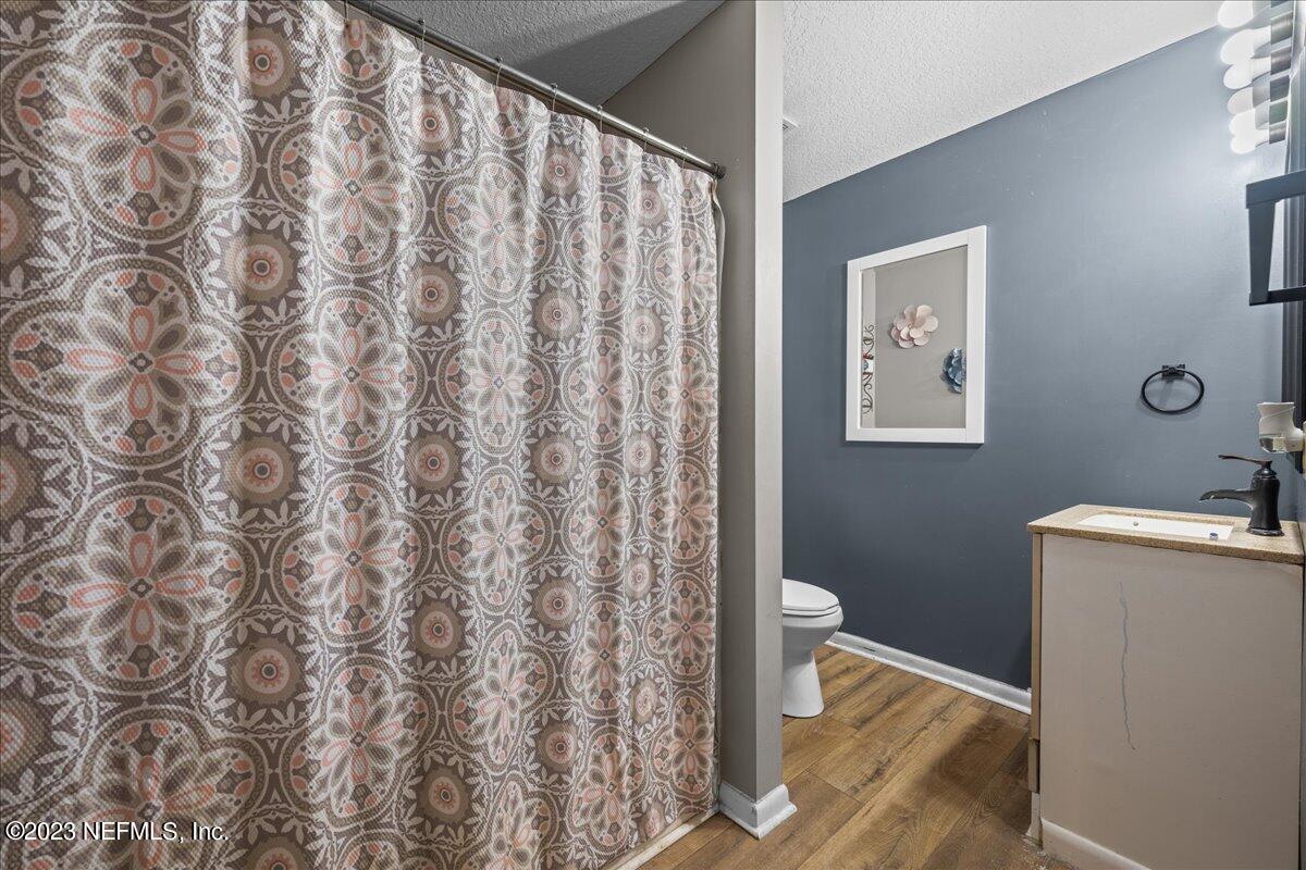 7145 Fitzpatrick Lane Jacksonville, FL 32226 - Photo 37 of 42 a bathroom with a granite countertop sink and a toilet