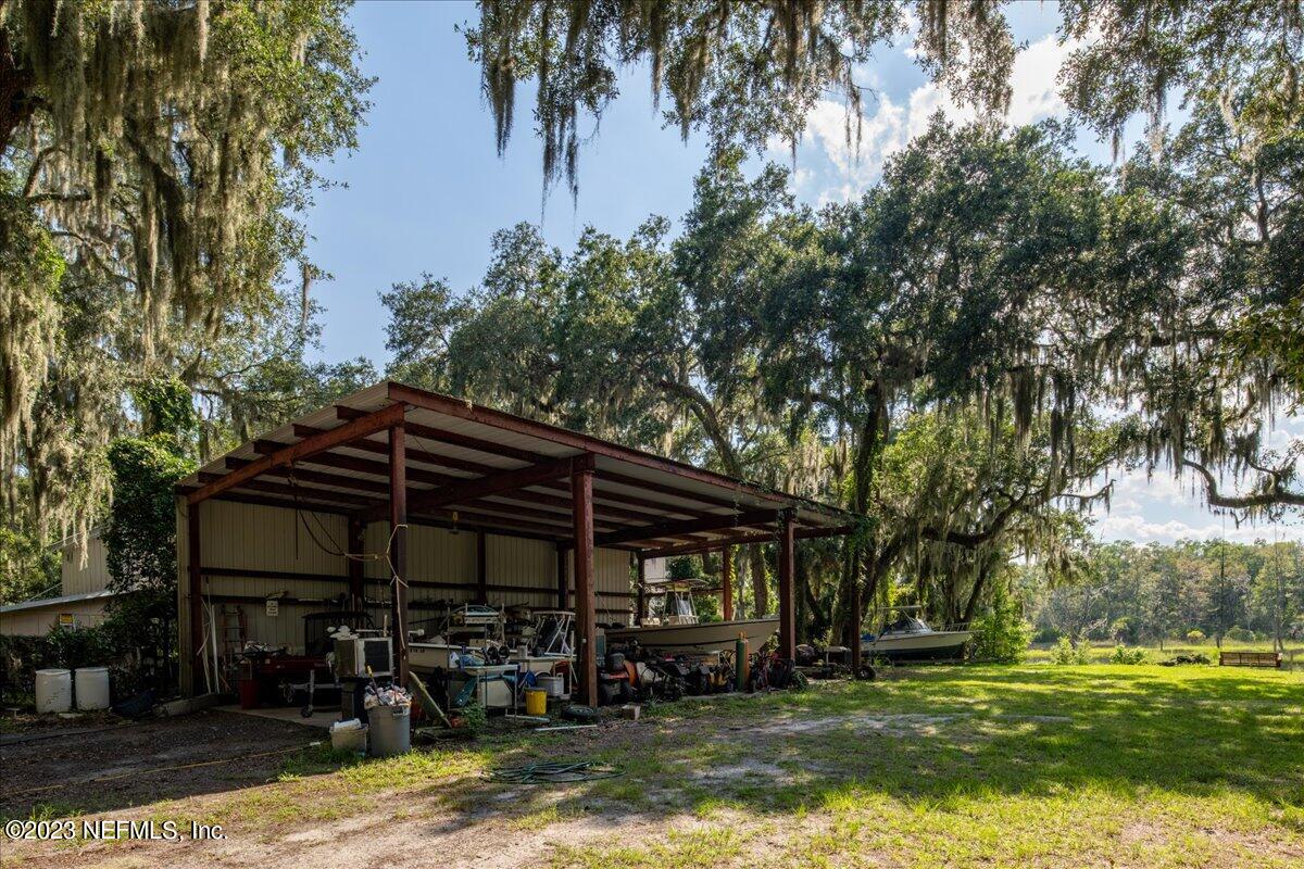 7145 Fitzpatrick Lane Jacksonville, FL 32226 - Photo 6 of 42 a backyard of a house with barbeque oven and outdoor seating
