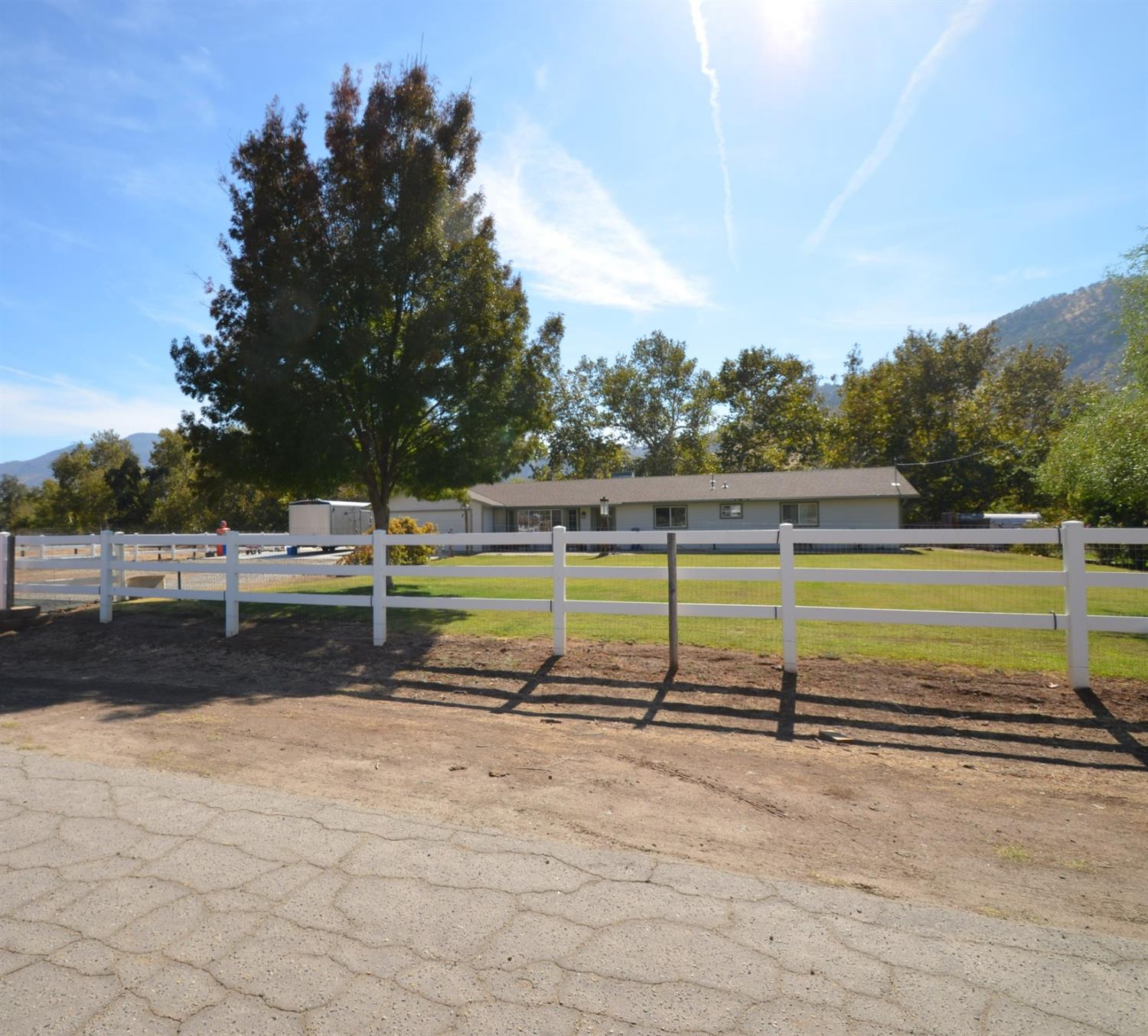 7453 Live Oak Drive Sanger, CA 93657 - Photo 1 of 28 a view of a tennis court with trees in the background