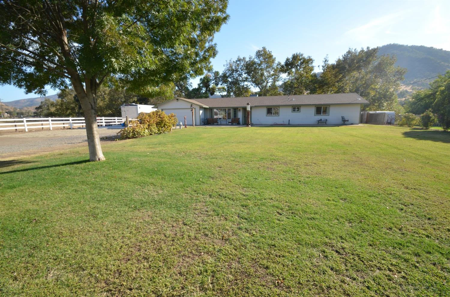 7453 Live Oak Drive Sanger, CA 93657 - Photo 2 of 28 a front view of a house with a yard