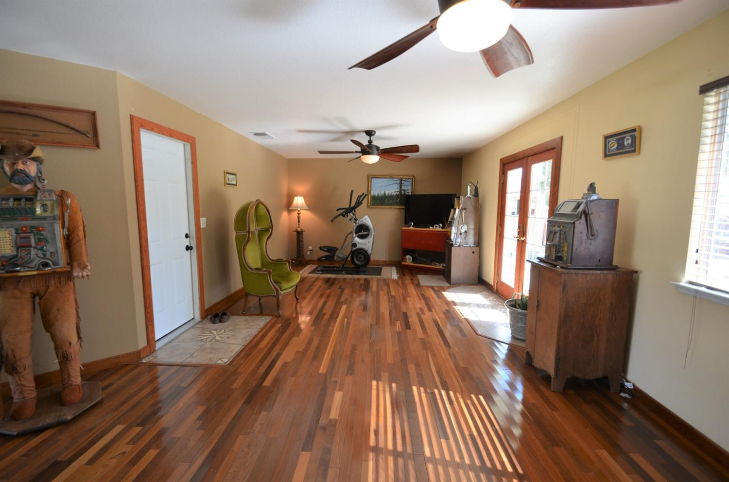 7453 Live Oak Drive Sanger, CA 93657 - Photo 14 of 28 a view of a livingroom with furniture a ceiling fan and wooden floor