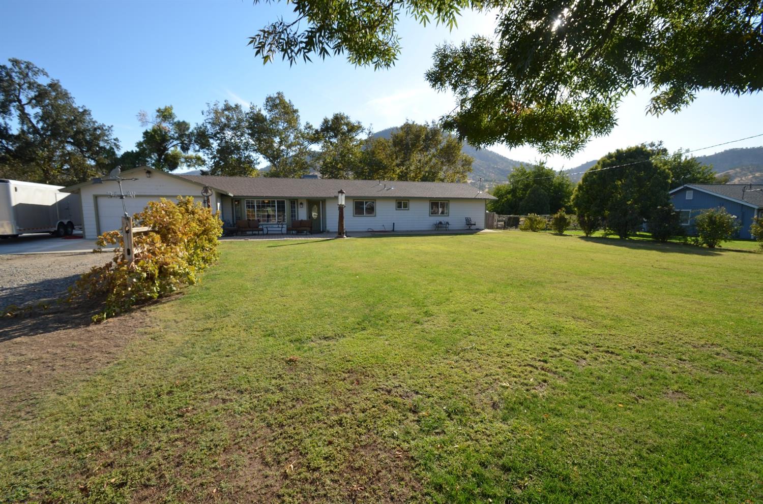 7453 Live Oak Drive Sanger, CA 93657 - Photo 28 of 28 a view of swimming pool with a yard and sitting area
