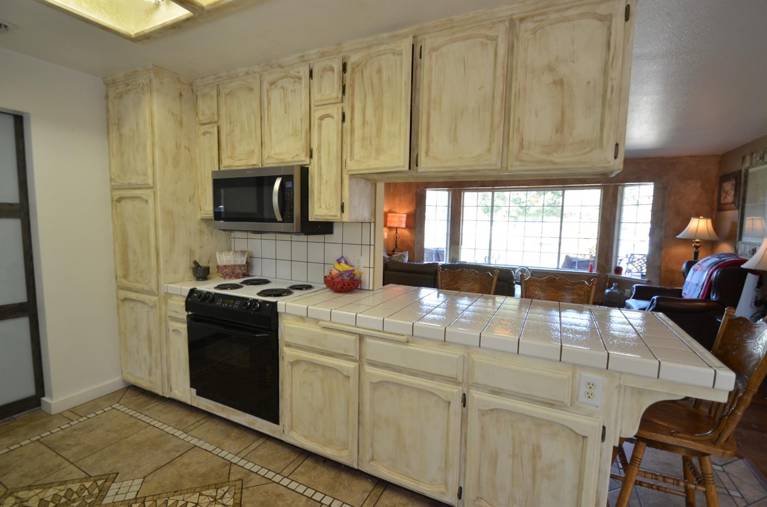 7453 Live Oak Drive Sanger, CA 93657 - Photo 9 of 28 a kitchen with stainless steel appliances granite countertop a stove a sink and a microwave