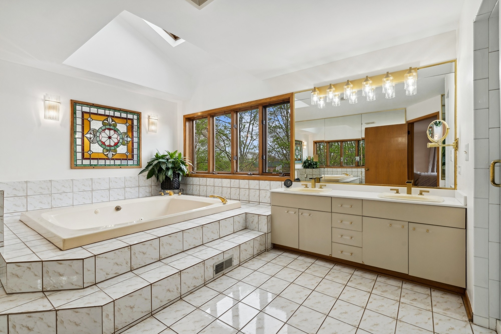 3606 Lawson Road Glenview, IL 60026 - Photo 26 of 62 a spacious bathroom with a double vanity sink a mirror and a bathtub