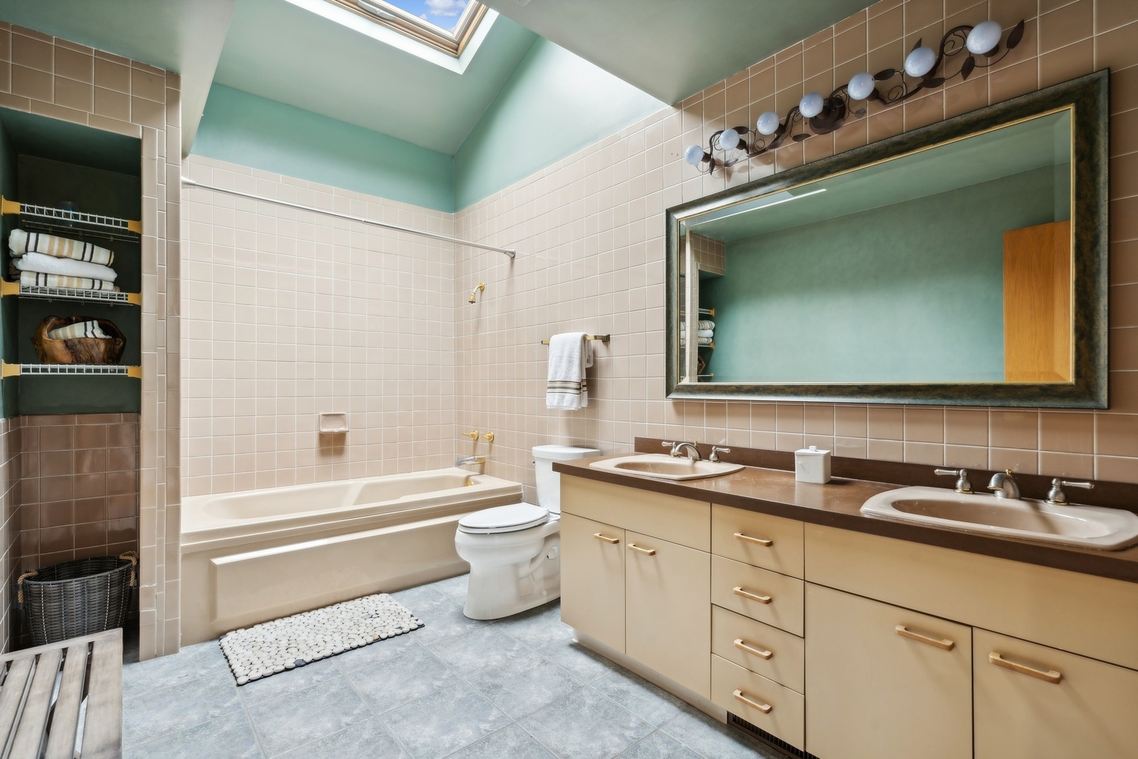 3606 Lawson Road Glenview, IL 60026 - Photo 33 of 62 a bathroom with a double vanity sink a mirror a bathtub and a shower