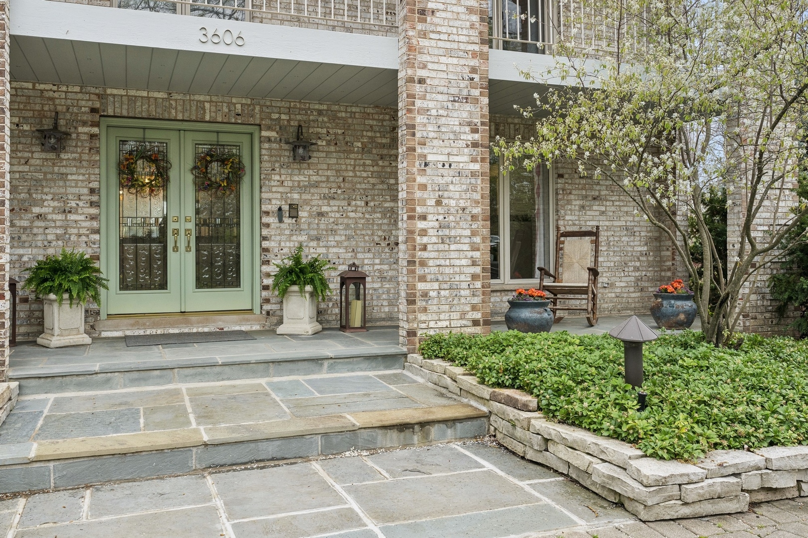 3606 Lawson Road Glenview, IL 60026 - Photo 48 of 62 a view of a house with potted plants and a fountain