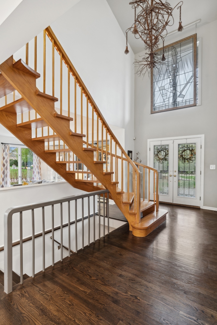 3606 Lawson Road Glenview, IL 60026 - Photo 5 of 62 a view of staircase with lots of frames on wall and wooden floor