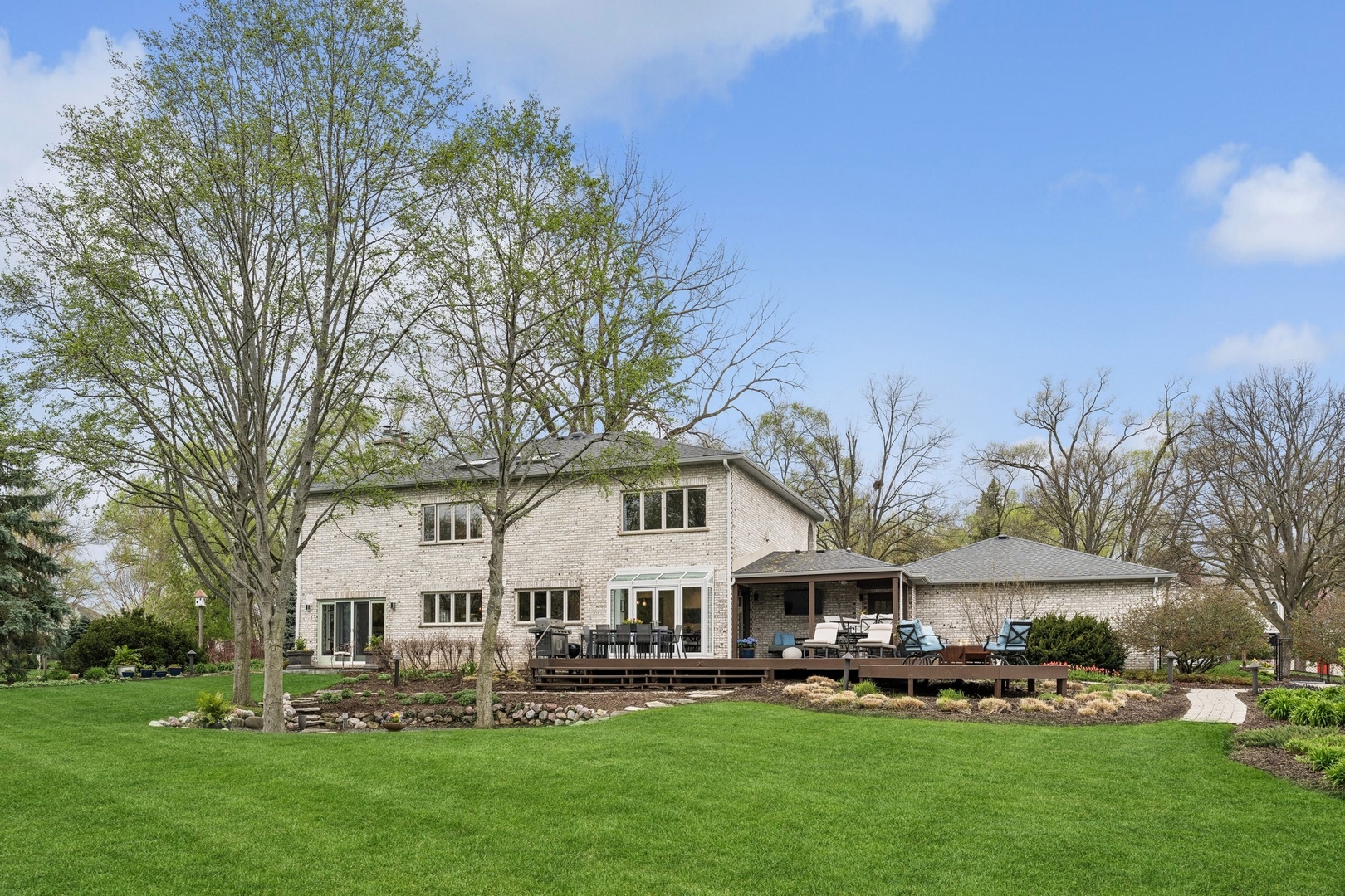 3606 Lawson Road Glenview, IL 60026 - Photo 56 of 62 a front view of a house with a garden and trees