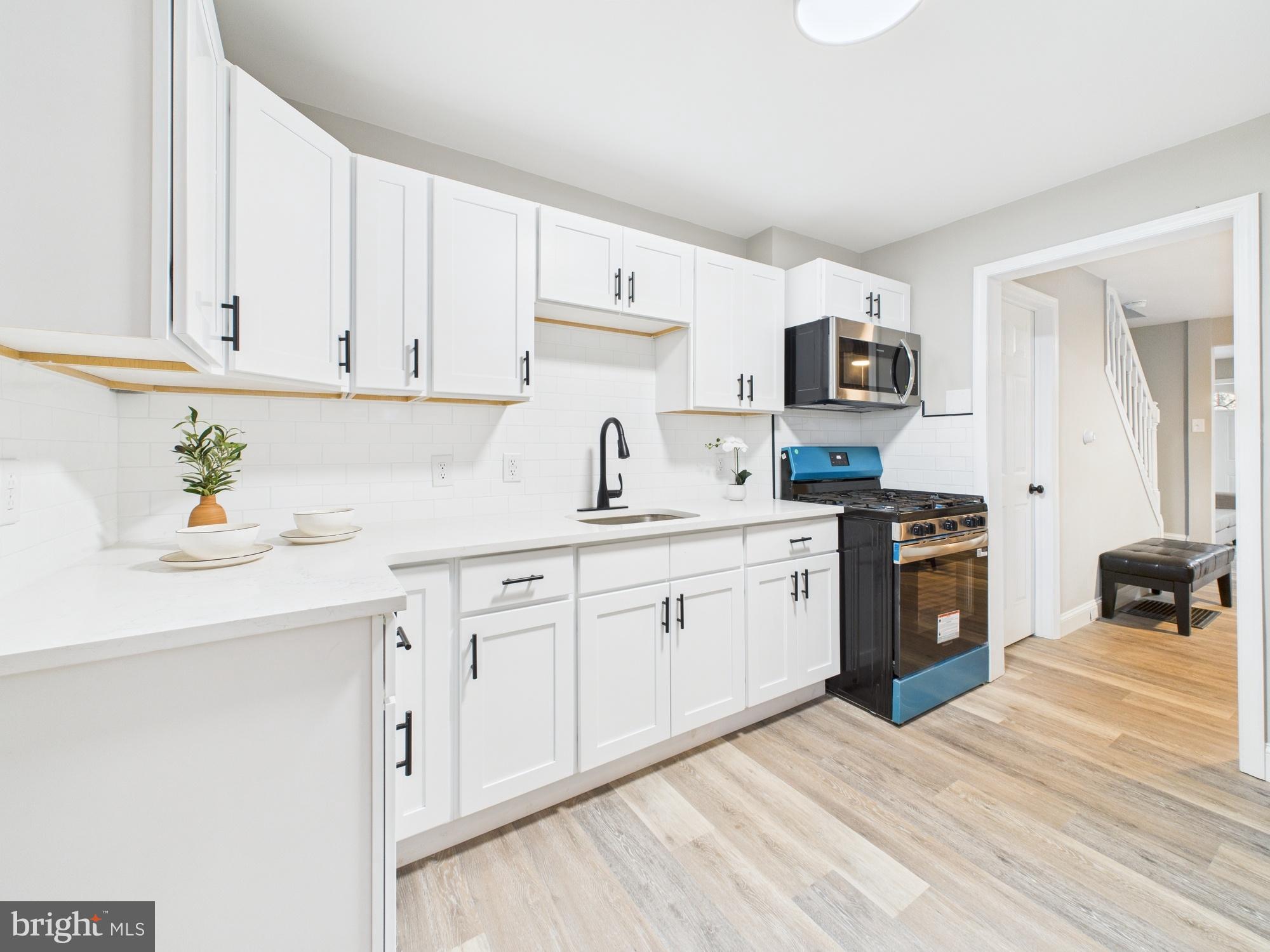 11 Denham Avenue Claymont, DE 19703 - Photo 11 of 28 Modern kitchen with sleek white cabinetry.
